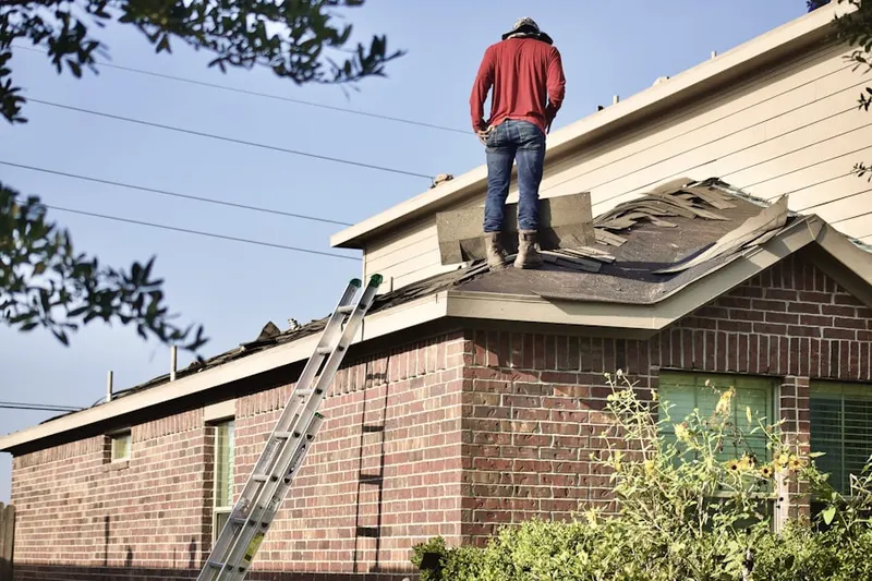 Professional roofer working on a residential roof in Lavon